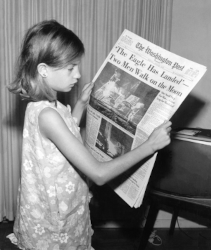 Jack Weir (1928-2005), Public domain, via Wikimedia Commons. A girl holding The Washington Post July 21, 1969 issue on Apollo 11 headline: "The Eagle Has Landed. Two Men [Neil Armstrong and Buzz Aldrin] Walk on the Moon". https://commons.wikimedia.org/wiki/File:Land_on_the_Moon_7_21_1969-repair.jpg